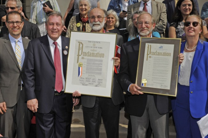 9/28/15 Robert Meeropol (pictured, pink shirt) and his brohter, Michael Meeropol, (pictured, blue shirt) received a proclamation from City Council member Daniel Dromm today. The proclamation recognized the contributions to the labor movement of Ethel Rosenberg, the mother of Robert and Michael. She was convicted of espionage along with her husband Julius in 1953 and was sentenced to death. Today would have marked her 100th birthday. Pictured, left to right: City Council member Mark Levine, City Council member Daniel Dromm, Robert Meeropol, Michael Meeropol and Gail Brewer. On the steps of City Hall, NY, NY . Please credit Gregory P. Mango.